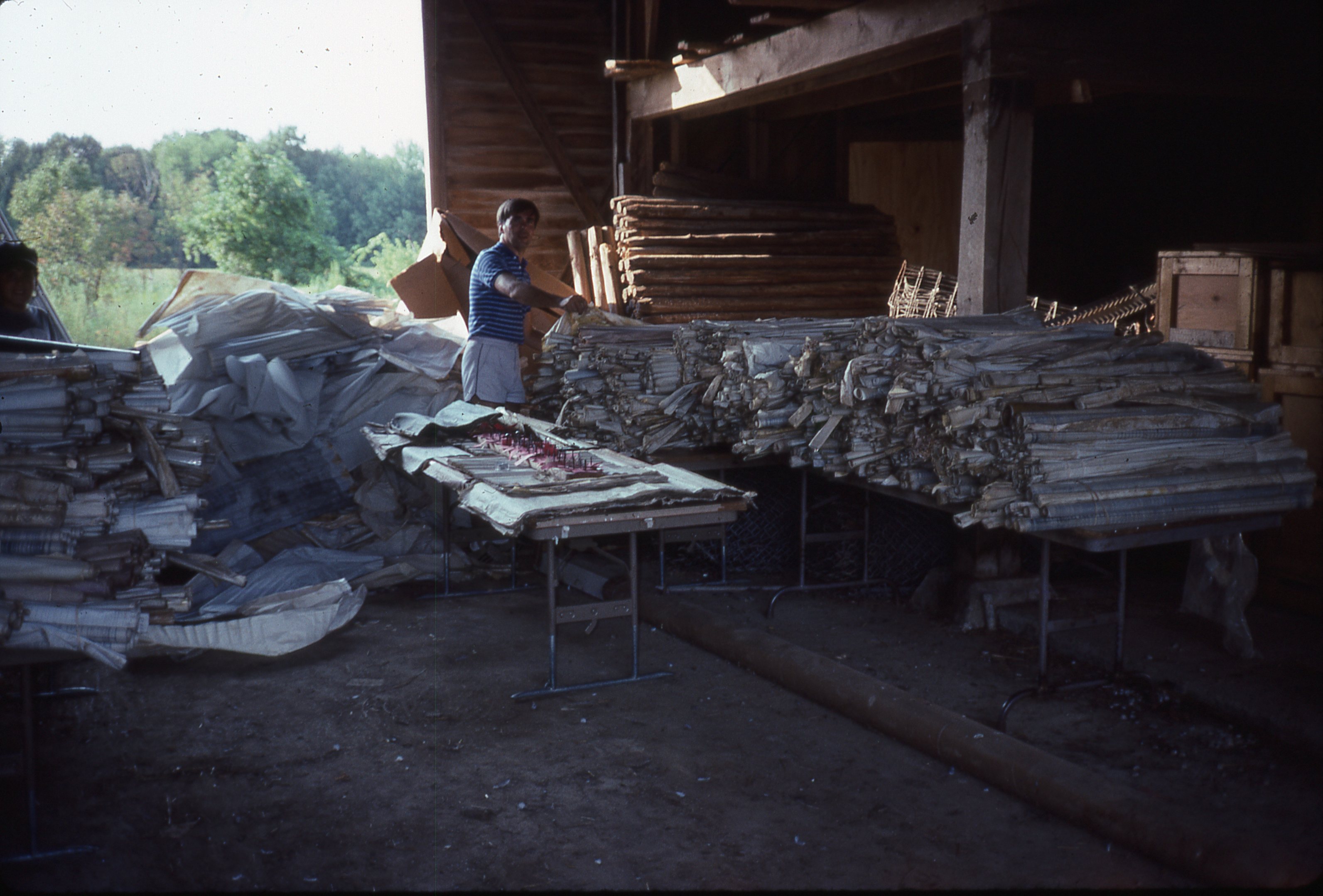 Ken sorting and drying wet drawings in a local barn.